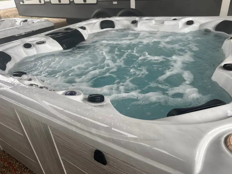 A white-shell hot tub running on display