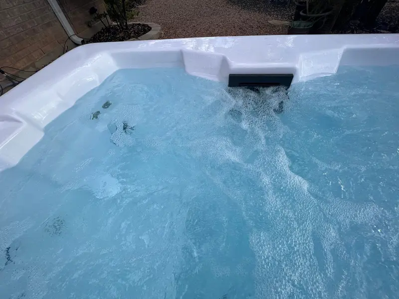 Bright blue water under a waterfall jet